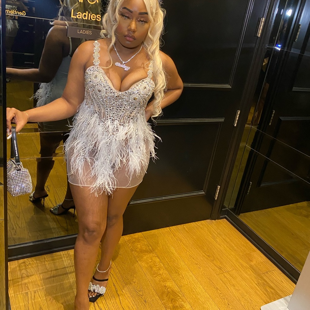 Diamond, pearl and lace dress with ostrich feathers.